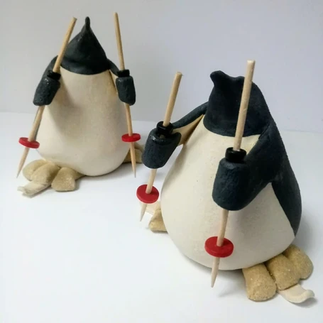 small ceramic penguins skiing