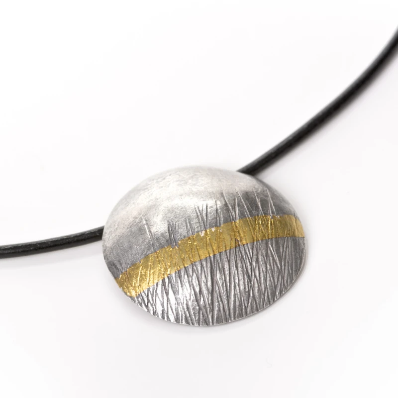 Textured oxidised silver, with a 24 carat gold str